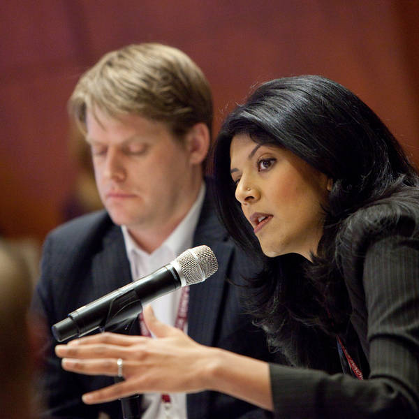 A woman talks into a Microphone